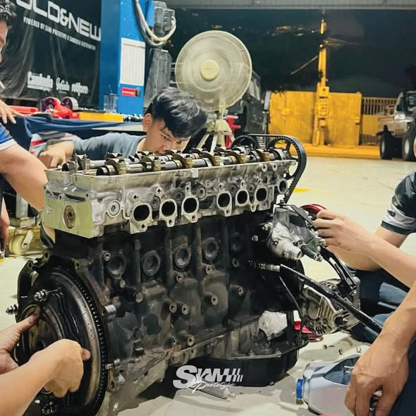 Crew working on the engine at night