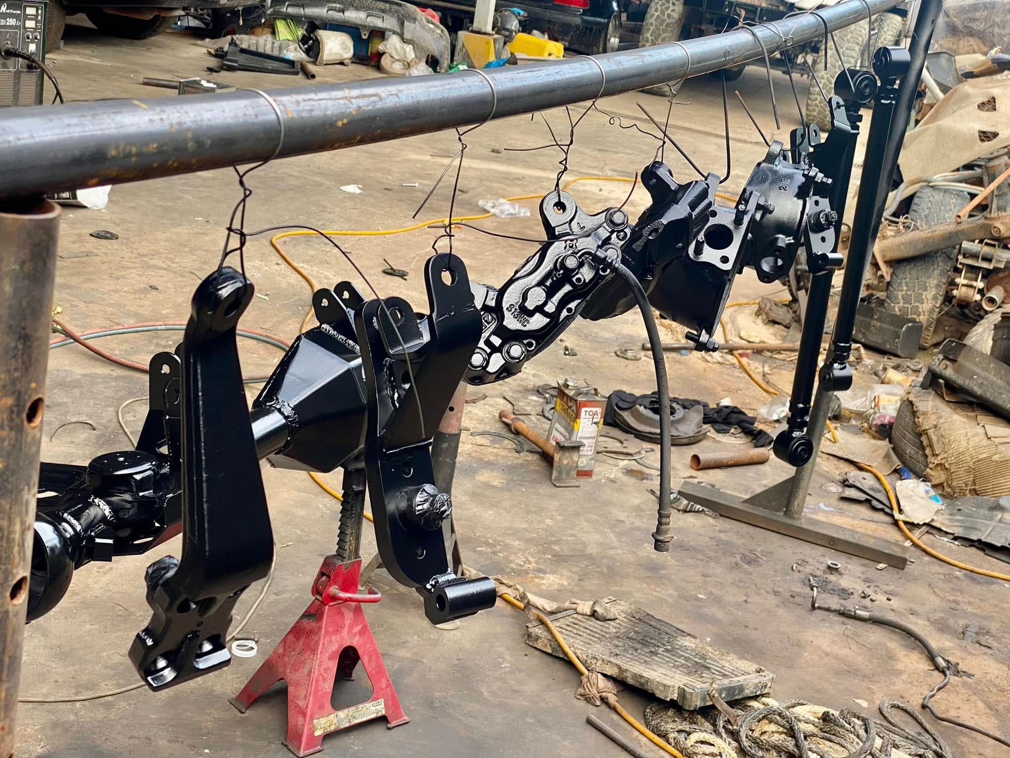 Axle components hanging to dry after paint
