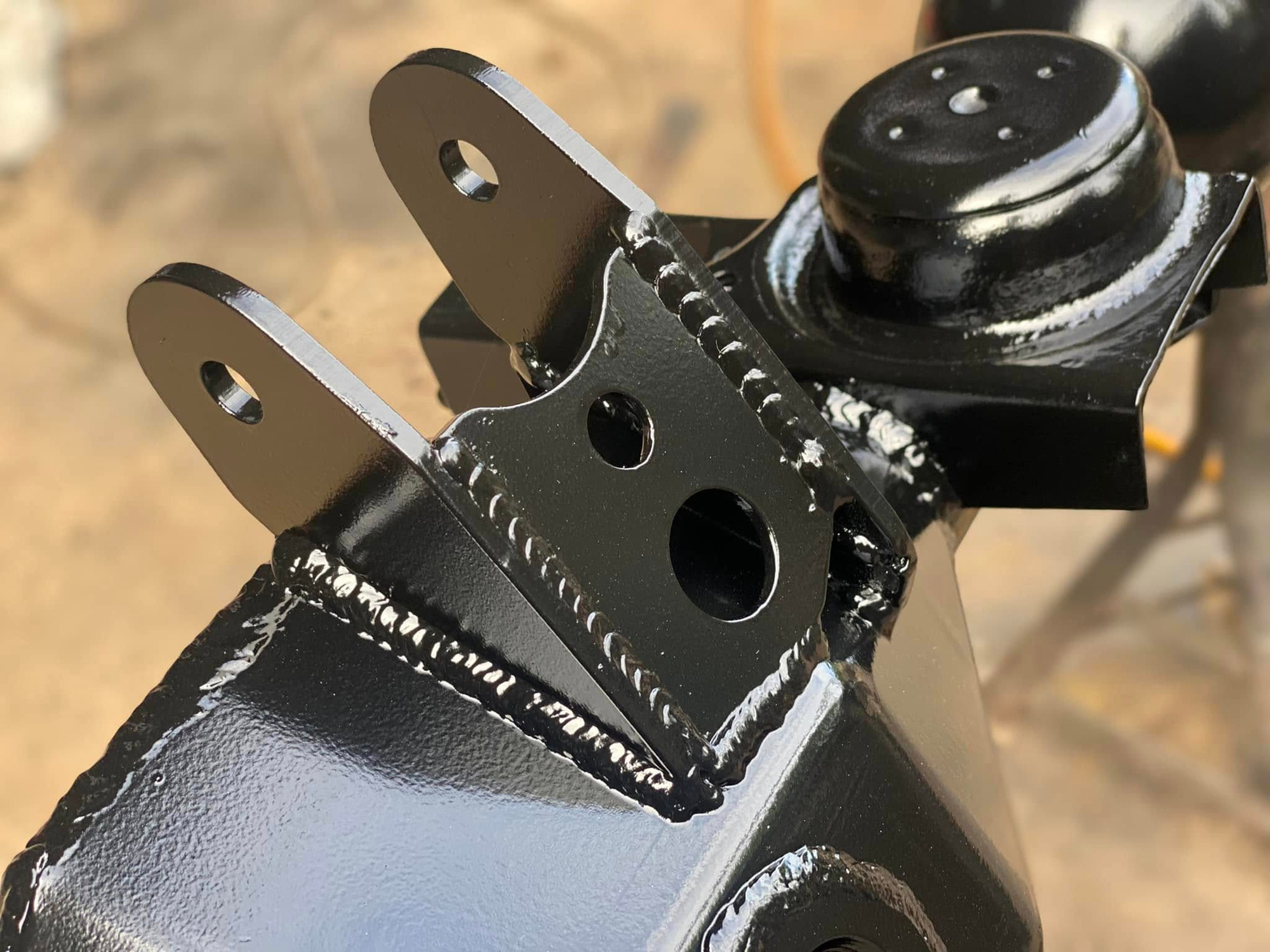 Axle mount bracket close-up with fresh paint